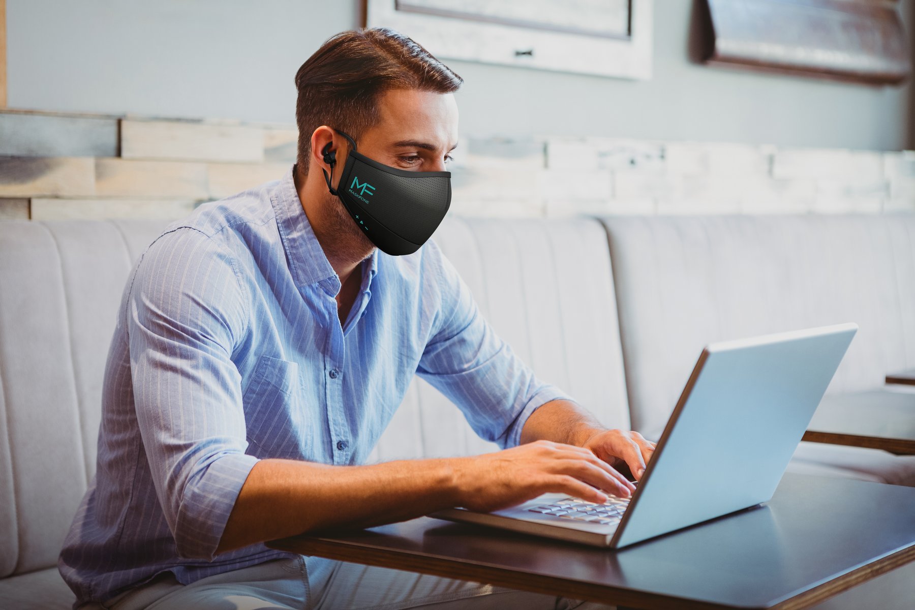 Person working on a laptop while wearing MaskFone